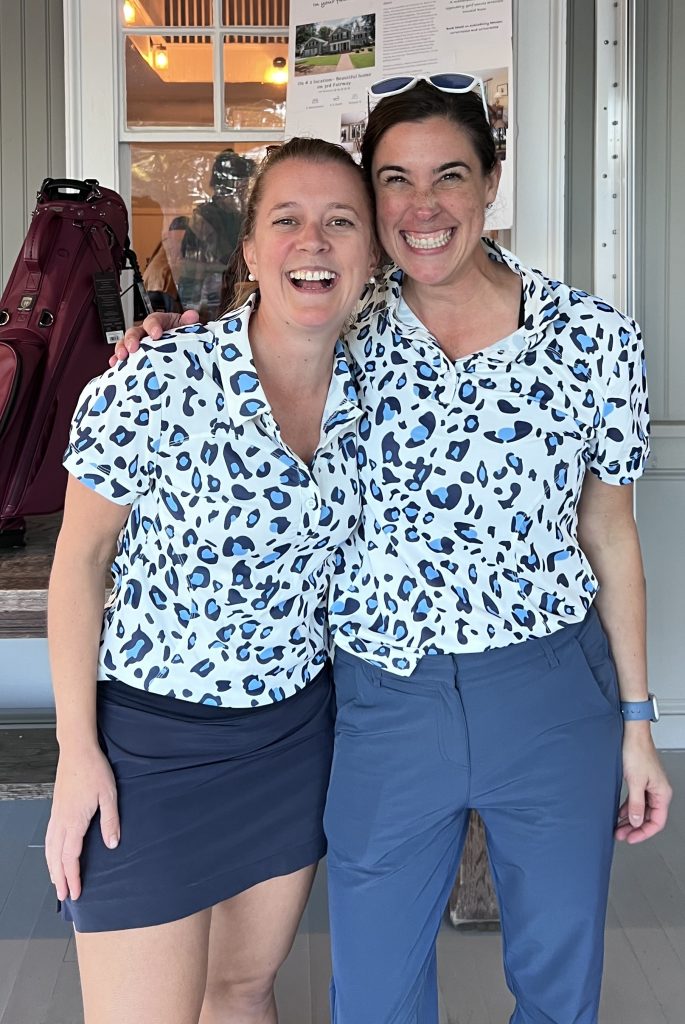 Two women smiling after winning awards